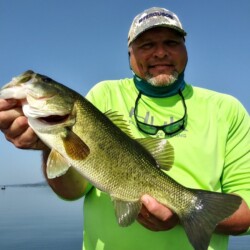 A man holding a fish he caught at Lake Guntersville.